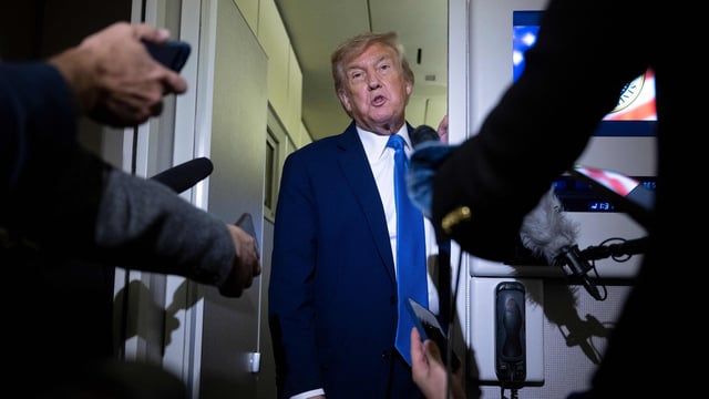 US President Donald Trump speaks to reporters about the G7 Summit aboard Air Force One while travelling back to Washington.