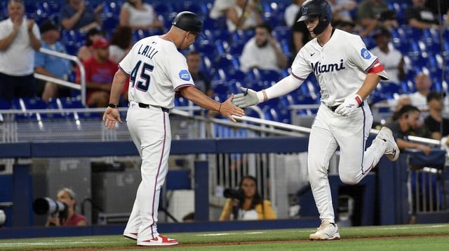 Jun 17, 2025; Miami, Florida, USA;  Miami Marlins’ Eric Wagaman is congratulated by third base coach Blake Lalli (45) after hitting a 2-run home run, during the 2nd inning, against the Philadelphia Phillies at loanDepot Park. Mandatory Credit: Michael Laughlin-Imagn Images