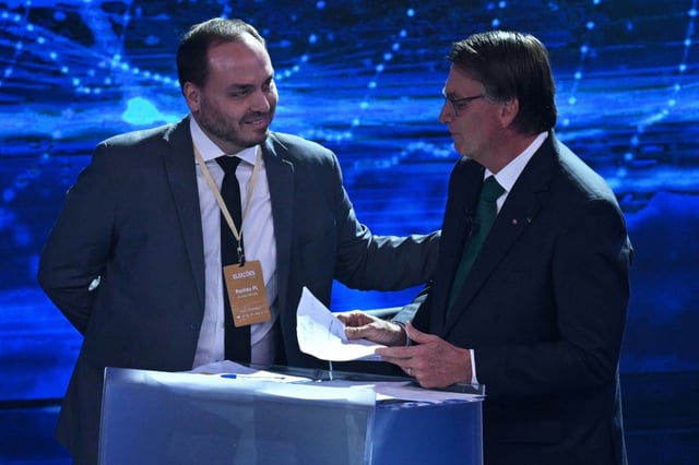Brazil's police are calling for charges against Carlos Bolsonaro (L), the son of former president Jair Bolsonaro (R), who is accused of involvement in an alleged illegal espionage network