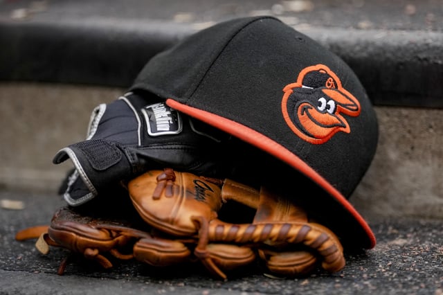 DETROIT, MICHIGAN - MAY 14: A Baltimore Orioles hat is pictured with Franklin batting gloves during the game against the Detroit Tigers at Comerica Park on May 14, 2022 in Detroit, Michigan.