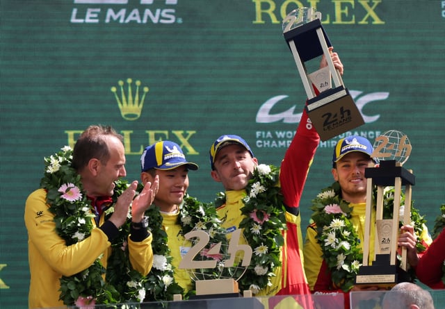 The 24 Hours of Le Mans - Circuit de la Sarthe, Le Mans, France - June 15, 2025 AF Corse's Robert Kubica, Yifei Ye and Philip Hanson celebrate with their medals and trophy on the podium after winning the 24 Hours of Le Mans along with team principal Amato Ferrari REUTERS/Stephane Mahe/File Photo