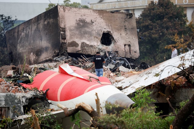 A fire officer stands next to the crashed Air India Boeing 787-8 Dreamliner aircraft, in Ahmedabad, India, June 13, 2025. REUTERS/Adnan Abidi/File Photo