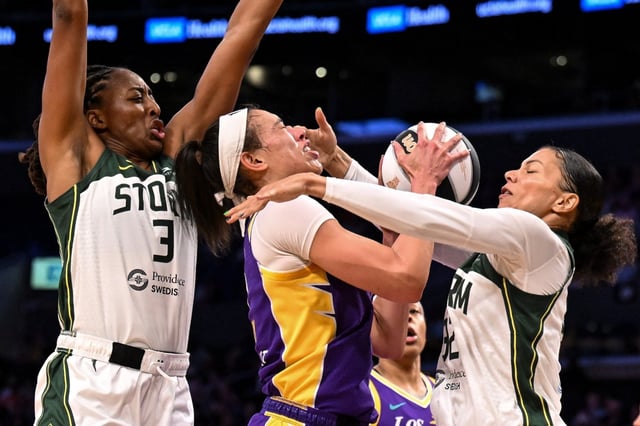 Sparks forward Dearica Hamby, center, is fouled by the Seattle Storm’s Alysha Clark, right, as Nneka Ogwumike, left, also defends during the first half on Tuesday night at Crypto.com Arena. (Photo by David Crane, Los Angeles Daily News/SCNG)