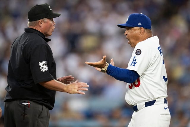 Dodgers manager Dave Roberts, right, argues with umpire Marvin Hudson after getting ejected during the third inning of their game against the San Diego Padres on Tuesday night at Dodger Stadium. (AP Photo/Kyusung Gong)