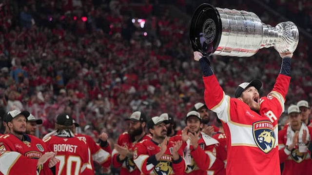 Florida Panthers left wing Matthew Tkachuk hoists the Stanley Cup.