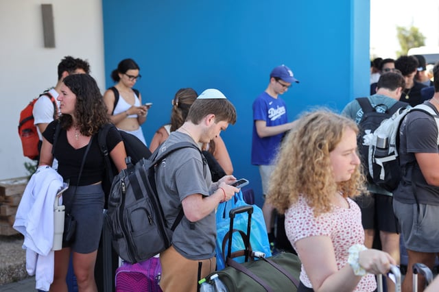 Passengers from the Crown Iris, a cruise ship, wait to board buses at the port of Larnaca, Cyprus, June 18, 2025. REUTERS/Yiannis Kourtoglou