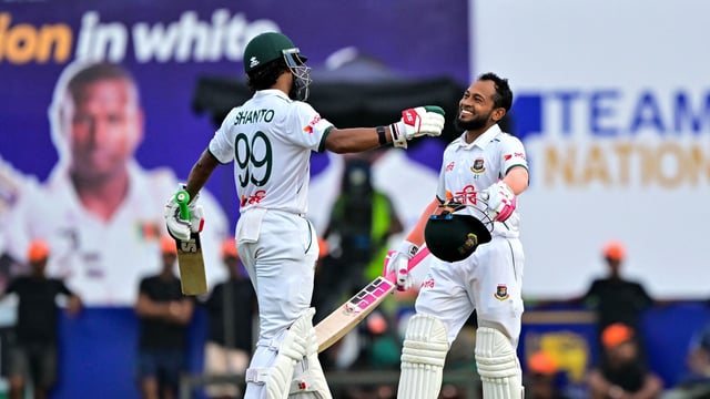 Mushfiqur Rahim (R) celebrates after scoring a century (100 runs) with captain Najmul Hossain Shanto during the first day of the first Test cricket match between Sri Lanka and Bangladesh