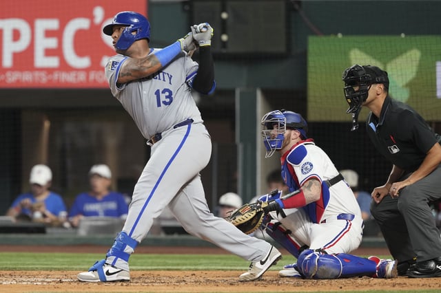 Jun 17, 2025; Arlington, Texas, USA; Kansas City Royals catcher Salvador Perez (13) follows through on his RBI double against the Texas Rangers during the fourth inning at Globe Life Field. Mandatory Credit: Jim Cowsert-Imagn Images