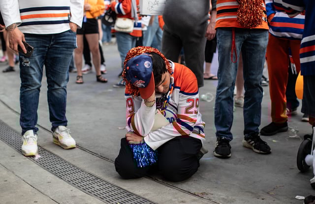 Fans react to the Edmonton Oilers losing to the Florida Panthers in Game 6 of the NHL Stanley Cup final during an outdoor viewing party in Edmonton, Tuesday, June 17, 2025.