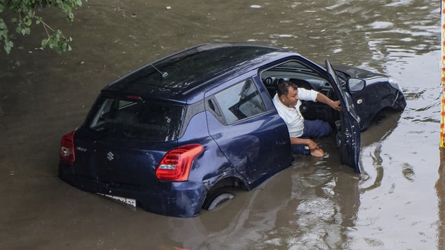 A viral image showed a man in distress as his car got stuck on a waterlogged Gurgaon road, following heavy downpour.
