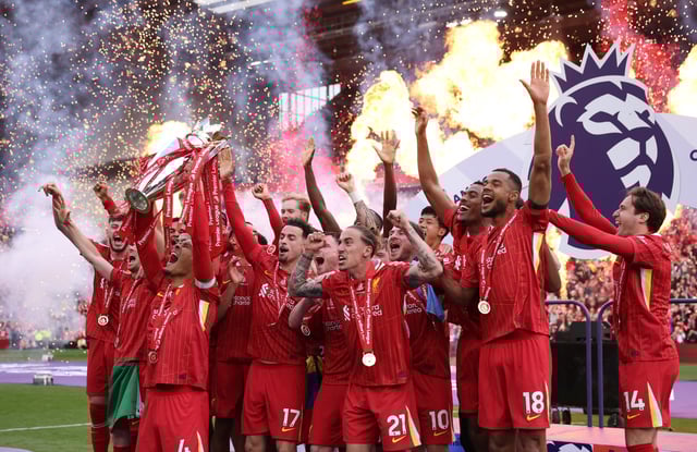 Soccer Football - Premier League - Liverpool v Crystal Palace - Anfield, Liverpool, Britain - May 25, 2025 Liverpool's Virgil van Dijk lifts the trophy as he celebrates with teammates after winning the Premier League REUTERS/Phil Noble/File Photo
