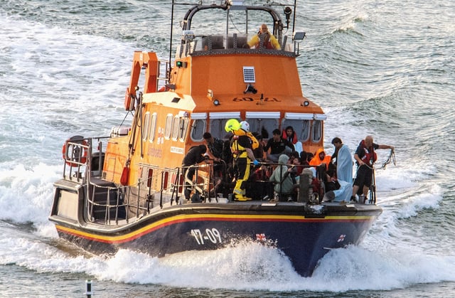 Rescue personnel bring migrants ashore, after a boat carrying migrants from France sunk in the English Channel, in Dover, Britain August 12, 2023, in this still image obtained from social media. Stuart Brock/via REUTERS/File Photo