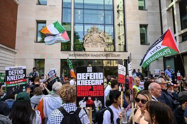 Protesters gather outside Westminster Magistrates' Court, on the day of the appearance of Kneecap member Liam O'Hanna, also known as Liam Og O hAnnaidh and performing under the name of Mo Chara, who has been charged with a terrorism offence in relation to the alleged display of a Hezbollah flag onstage in 2024, in London, Britain, June 18, 2025. REUTERS/Jaimi Joy
