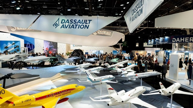 Display models of Dassault Aviation SA aircraft, including Falcon firefighter and executive jets at the Paris Air Show in Paris, France.