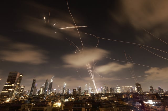 Israeli air defence systems are activated to intercept Iranian missiles over the Israeli city of Tel Aviv early on June 18, 2025. Israel and Iran exchanged fire again on June 17, the fifth day of strikes in their most intense confrontation in history, fuelling fears of a drawn-out conflict that could engulf the Middle East.