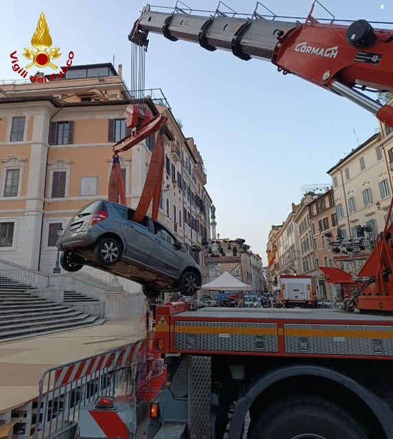 This image shared by Vigili del Fuoco, Italy’s fire and rescue service, shows a vehicle being removed after it drove down and got stuck on Rome’s Spanish Steps, on Tuesday, June 17, 2025.