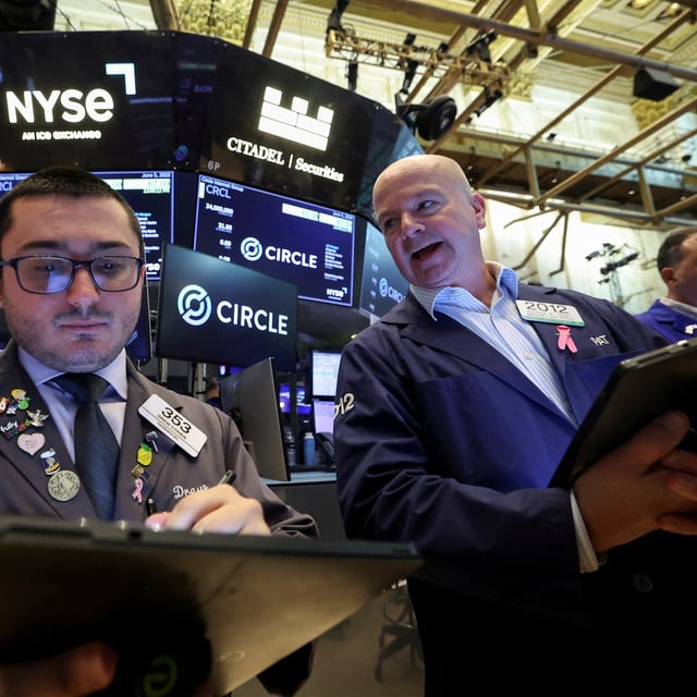 FILE PHOTO: Traders work on the floor at the New York Stock Exchange (NYSE), on the day of Circle Internet Group's IPO, in New York City, U.S., June 5, 2025.  REUTERS/Brendan McDermid/File Photo