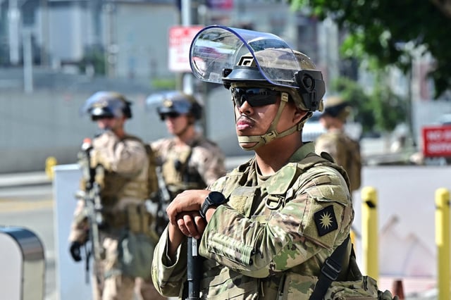Members of the California National Guard stand watch in front of the Edward Roybal Federal Building on the morning of June 17, 2025 in Los Angeles, California. 