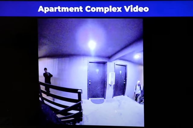 A still from a video shown during an Aurora Police news conference shows multiple armed individuals moments after knocking on an apartment door, recorded June 9, 2025, at an apartment complex in Aurora, Colorado. (Screenshot via YouTube)