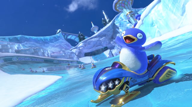 Penguin riding a snowmobile on an icy track in Mario Kart World.