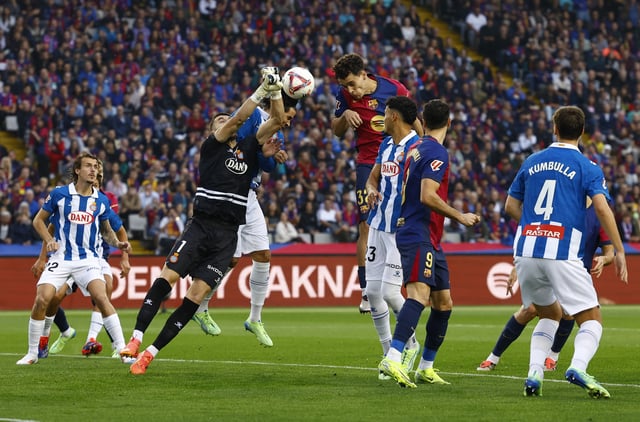 Soccer Football - LaLiga - FC Barcelona v Espanyol - Estadi Olimpic Lluis Companys, Barcelona, Spain - November 3, 2024 RCD Espanyol's Joan Garcia in action with FC Barcelona's Hector Fort REUTERS/Albert Gea/File Photo