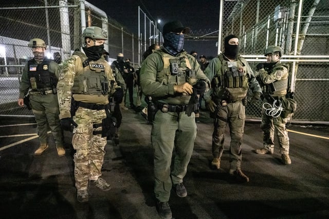U.S. Immigration and Customs Enforcement (ICE) agents guard outside Delaney Hall, a migrant detention facility, while anti-ICE activists demonstrate on June 12, 2025 in Newark, New Jersey. Anti-ICE protests have been spreading to cities across America since Ice deportation quotas have increased.