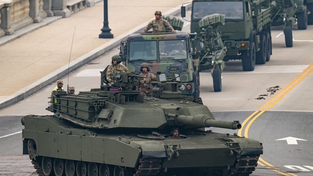 Members of the US Army drive a M1 Abrams tank across the Memorial Bridge during the Army 250th Anniversary Parade in Washington, DC, on June 14, 2025. 