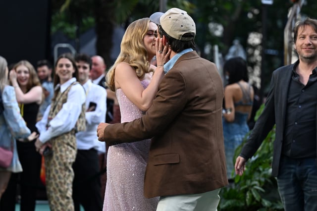 Scarlett Johansson and costar Jonathan Bailey kiss at the London premiere of "Jurassic World Rebirth."