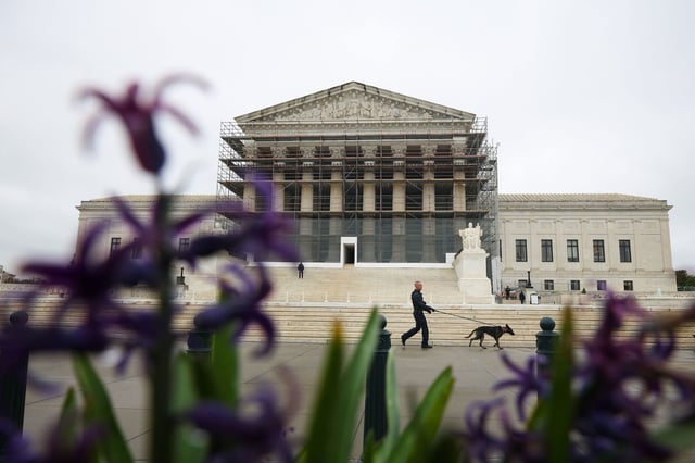 WASHINGTON, DC - APRIL 07: A member of the Capitol Police K-9 unit walks a dog in front of the U.S. Supreme Court is on April 07, 2025 in Washington, DC. On Monday, the Trump administration requested that the Supreme Court block a lower court's order stating that officials must return a man mistakenly deported to El Salvador to Maryland. (Photo by Kayla Bartkowski/Getty Images)