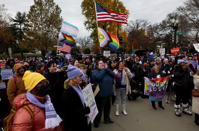 People gather and react outside the U.S. Supreme Court on the day it heard arguments over an appeal by U.S. President Joe Biden's administration of a lower court's decision upholding a Republican-backed ban in Tennessee on gender-affirming medical care for transgender minors, in Washington, U.S., December 4, 2024. REUTERS/Leah Millis/File Photo