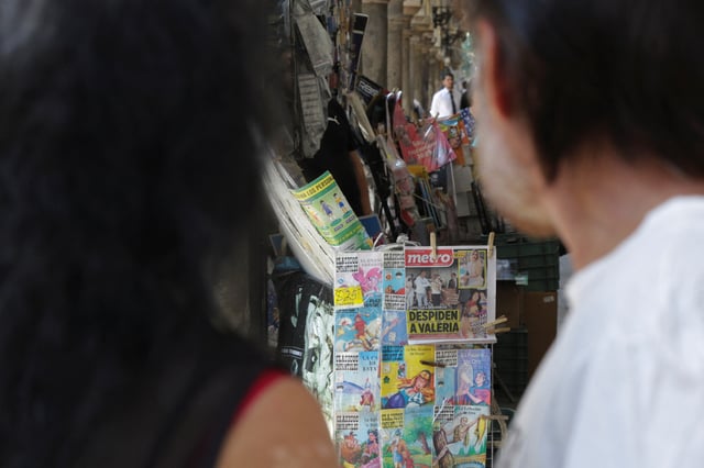 People stand next to a newsstand displaying a front page covering the funeral Mass of Valeria Marquez, 23, a Mexican social media influencer who was fatally shot during a TikTok livestream, in Guadalajara, Mexico, May 16, 2025. REUTERS/Stringer