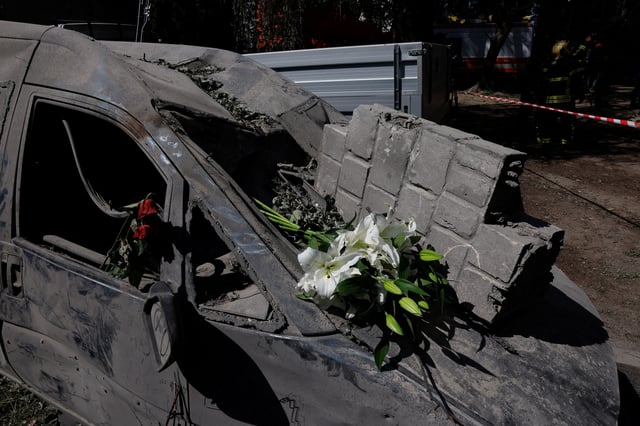 Debris and flowers lie on a vehicle, at the site of an apartment building damaged on Tuesday during Russian drone and missile strikes, amid Russia's attack on Ukraine, in Kyiv, Ukraine June 18, 2025. REUTERS/Alina Smutko