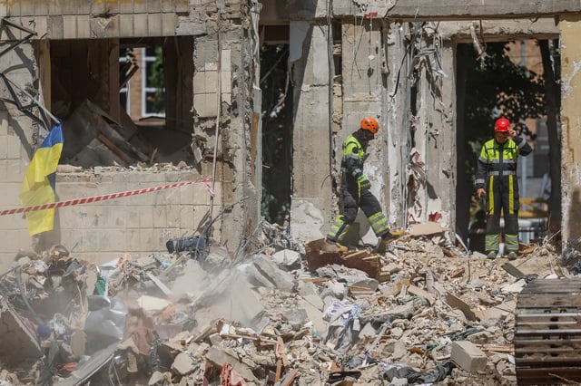 Rescuers search for the body of a person under debris of an apartment building hit by a Russian missile strike on Tuesday, amid Russia's attack on Ukraine, in Kyiv, Ukraine, June 18, 2025. REUTERS/Alina Smutko