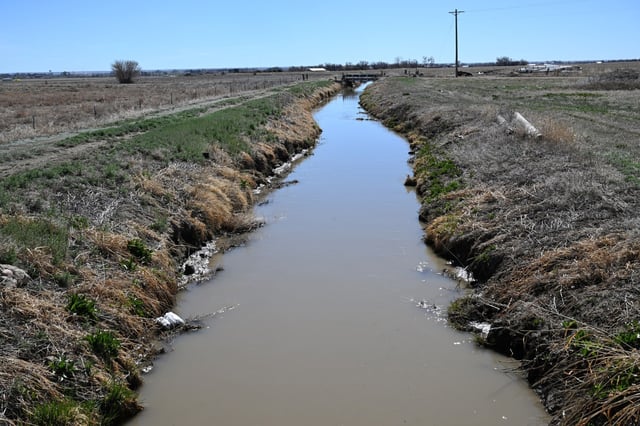 The water in the Rocky Ford ditch, which looks muddy and unclean, runs near areas that used to be farmed with water from the Lower Arkansas river in Rocky Ford, Colorado on March 25, 2025. Colorado Springs is going to need 34,000 more acre-feet a year of water in the coming decades to meet demand when the city is fully built out. Farmers in the Lower Arkansas Valley have spoken against the city&#39;s annexations of new housing developments outside the city limits since they increase the amount of water the city will need in the future. (Photo by Helen H. Richardson/The Denver Post)