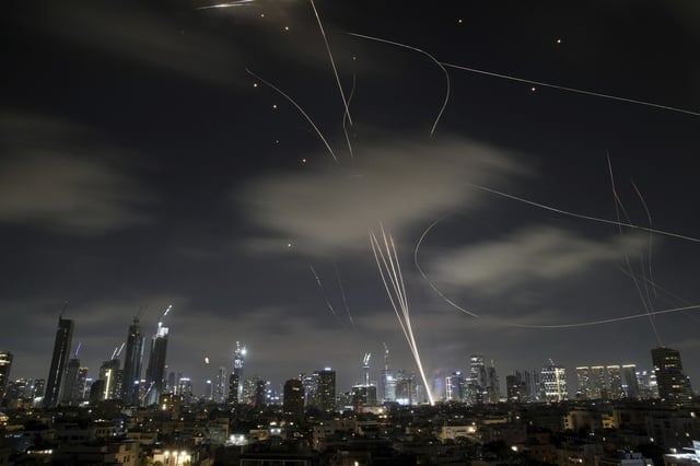 The Israeli Iron Dome air defense system fires to intercept missiles during an Iranian attack over Tel Aviv, Israel, early Wednesday June 18, 2025.