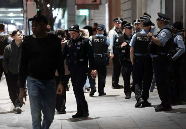 Chicago police fill a sidewalk on East Illinois Street near the AMC River East 21 movie theater, April 18, 2025. Gatherings of teens in the area have resulted in violence. (Terrence Antonio James/Chicago Tribune)