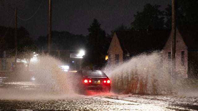 A car drives through a flooded section of south Hillside near Lincoln on Tuesday night after a day of heavy rains in the area.