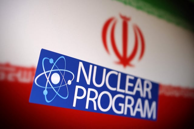 Iranian flag, atom symbol and words "Nuclear program" are in this illustration taken June 16, 2025. REUTERS/Dado Ruvic/Illustration
