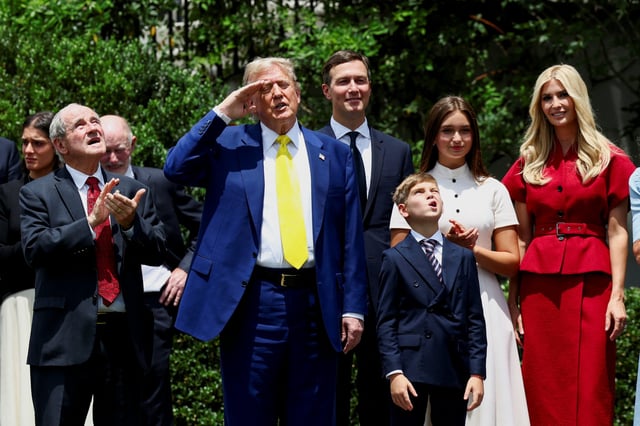 U.S. President Donald Trump, next to his daughter Ivanka Trump and her husband Jared Kushner, salutes as a U.S. flag is raised on a new flagpole installed on the South Lawn of the White House in Washington, D.C., U.S. June 18, 2025.