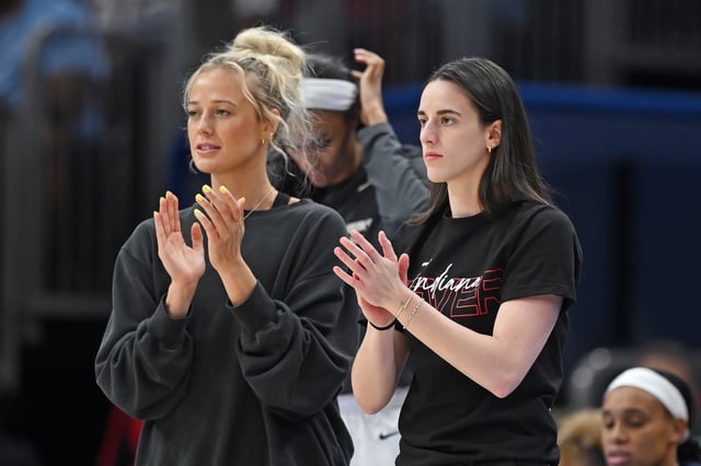 Sophie Cunningham #8 and Caitlin Clark #22 of the Indiana Fever cheer from the bench against the Chicago Sky at the United Center on June 07, 2025 in Chicago, Illinois.