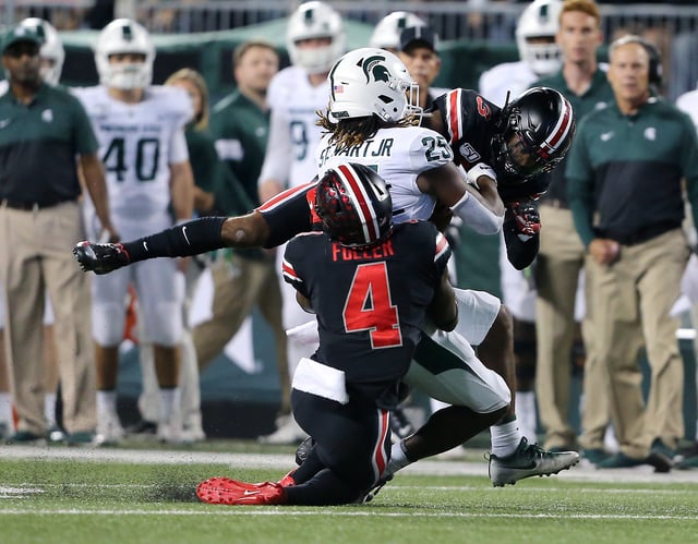 Oct 5, 2019; Columbus, OH, USA; Michigan State Spartans wide receiver Darrell Stewart Jr. (25) is run down by Ohio State Buckeyes safety Jordan Fuller (4) and cornerback Damon Arnette (3) during the second quarter at Ohio Stadium.  Mandatory Credit: Joe Maiorana-USA TODAY Sports/File Photo