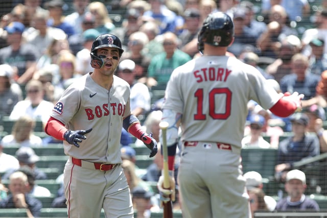 Boston Red Sox Marcelo Mayer, left, celebrates with Trevor Story (10) after hitting a solo home run off Seattle Mariners starting pitcher Luis Castillo during the second inning of a baseball game, Wednesday, June 18, 2025, in Seattle. (AP Photo/Jason Redmond)