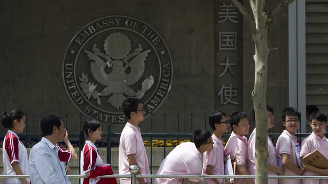 Chinese students wait outside the U.S. Embassy for their visa application interviews, in Beijing on May 2, 2012. 
