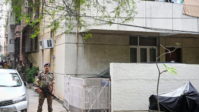 Security personnel seen stationed outside an office where an ED raid was conducted on Wednesday. (Sanchit Khanna/Hindustan Times)
