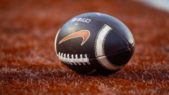 Dec 21, 2024; Austin, Texas, USA; Detailed view of a Nike logo on an official NCAA football during the Clemson Tigers game against the Texas Longhorns in the CFP National playoff first round at Darrell K Royal-Texas Memorial Stadium. Mandatory Credit: Mark J. Rebilas-Imagn Images