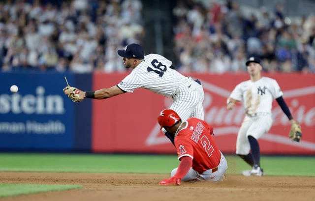 NEW YORK, NEW YORK - JUNE 18: Luis Rengifo #2 of the Los Angeles Angels is safe at second base in the eighth inning as Oswald Peraza #18 of the New York Yankees can&#39;t come up with the ball thrown for an error by Anthony Volpe #11 of the New York Yankees at Yankee Stadium on June 18, 2025 in New York City. A run scored on the play giving the Angels a 3-2 lead. (Photo by Jim McIsaac/Getty Images)
