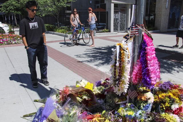 A young man pays his respects to Arthur Folasa Ah Loo, known to friends and family as Afa, on June 17, 2025, at a makeshift memorial in Salt Lake City, on the block where Ah Loo was fatally shot during a "No Kings" protest on Saturday, June 14.