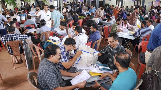 Polling officials receive electoral material at a polling center on the eve of Nilambur Assembly by-election, at Chungathara Marthoma Higher Secondary School, in Malappuram district, Kerala, Wednesday, June 18, 2025. 