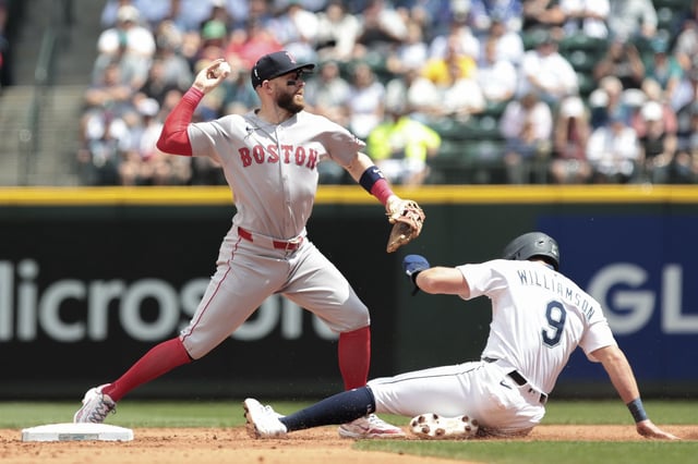 Boston Red Sox shortstop Trevor Story, left, tags to get Seattle Mariners' Ben Williamson (9) out at second during the second inning of a baseball game, Wednesday, June 18, 2025, in Seattle. (AP Photo/Jason Redmond)