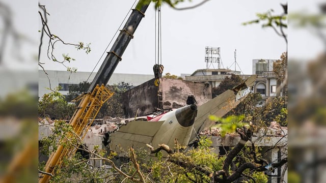 Ahmedabad: A crane being used to clear the debris of the crashed Air India plane...
